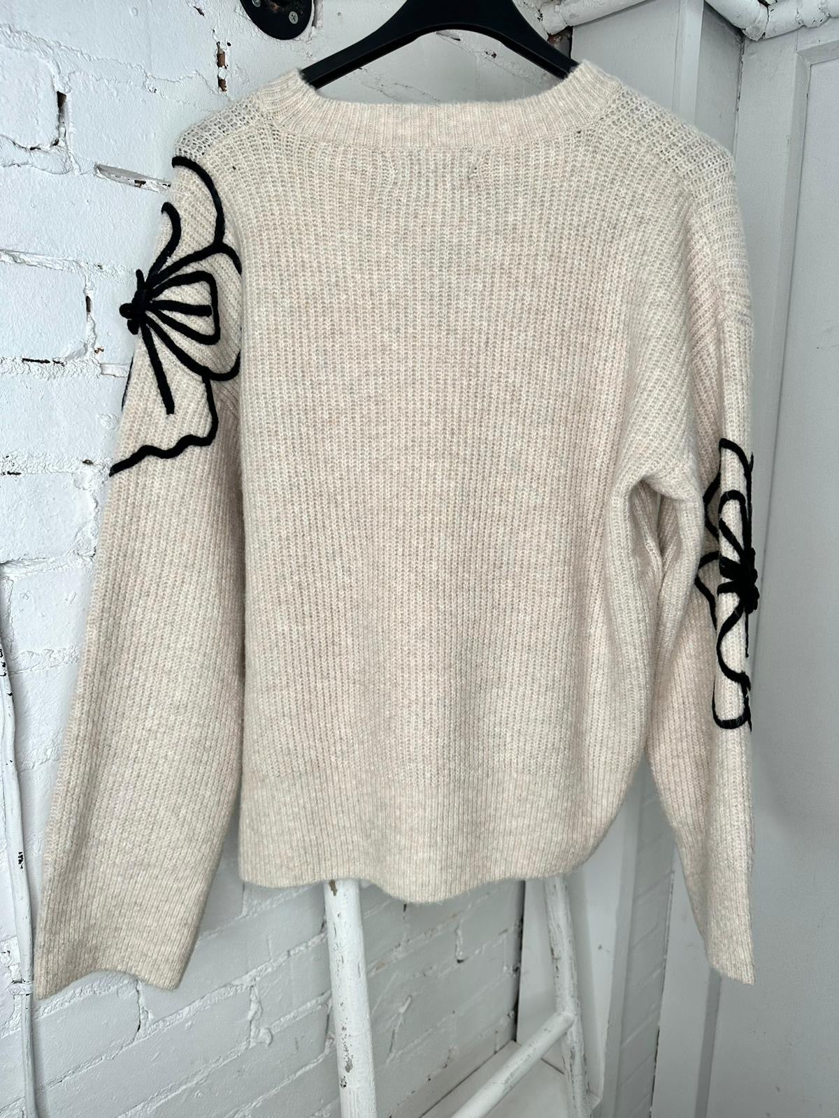 Beige soft jumper with black flower embroidery