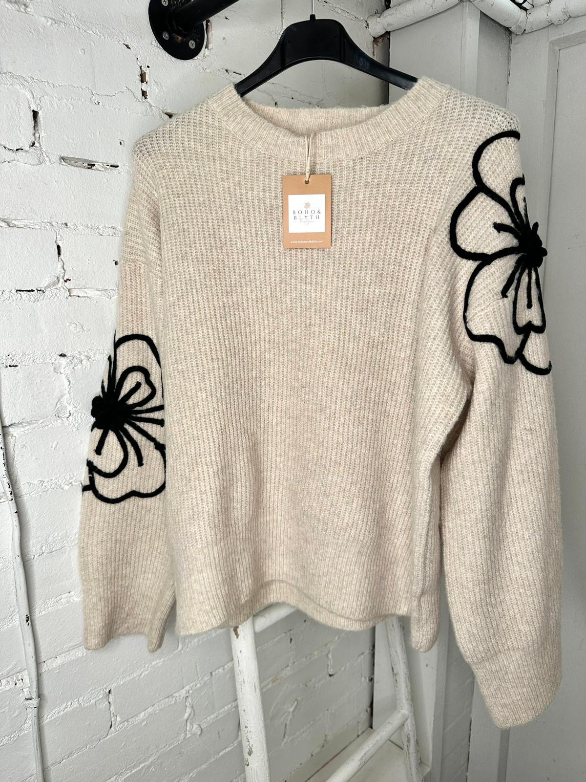 Beige soft jumper with black flower embroidery